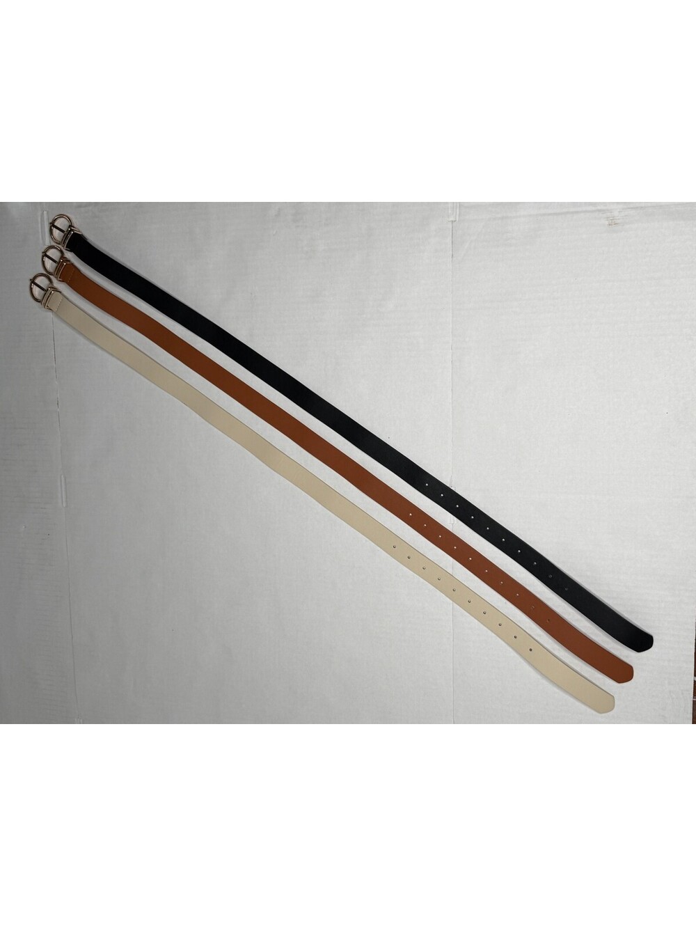 Women's Set of 3 Gold Buckle Accented Belts in Black, Brown and Cream.